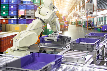 Industry 4.0 Robot concept .The robot arm is working smartly in the shipping department of the factory.