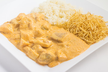 Tilapia. Fish fillet Stroganoff with potato sticks and rice