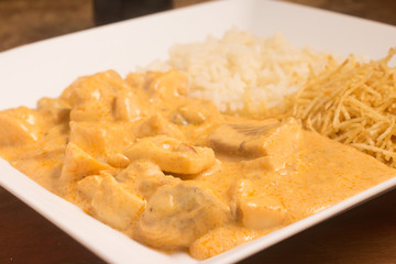 Tilapia. Fish fillet Stroganoff with potato sticks and rice