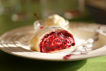Photo of a macro of delicious bright strudel with cherry
