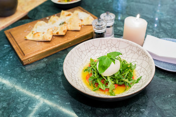 fresh salad with cheese and rucola dressed with pesto sauce