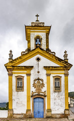 Old withe and yellow catholic church of the 18th century located in the center of the famous and historical city of Ouro Preto in Minas Gerais