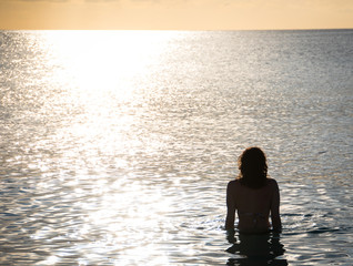 Girl in Ocean Watching Sunset