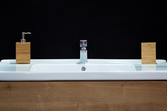sink with a faucet and wood trim in a cozy and stylish bathroom
