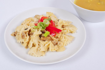 Wholemeal pasta baked with cabbage on a white