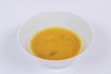 Pumpkin soup with leek on a white