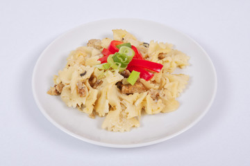 Wholemeal pasta baked with cabbage on a white