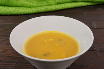 Pumpkin soup with leek on a table