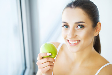 Woman Eating Apple. Beautiful Girl With White Teeth Biting Apple. High Resolution Image