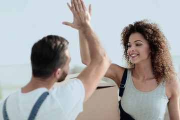 Happy and young couple giving a high five