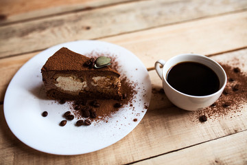 coffee cake with a cup of coffee on a wooden background in daylight