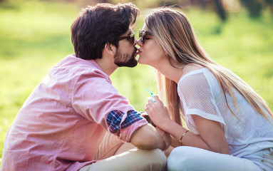 Couple in love. Romantic couple enyojing in moments of happiness in the city park. Love and tenderness, dating, romance. Lifestyle concept