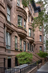 a row of colorful brownstone buildings in a historic neighborhood of Brooklyn in New York City