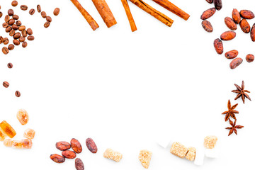 Ingredients for bakery and desserts. Cinnamon, cocoa, sugar, spices on white background top view space for text