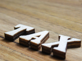 wooden word, 'tax' inscription on a wooden background