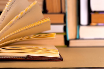 Open book, hardback books on bright colorful background.