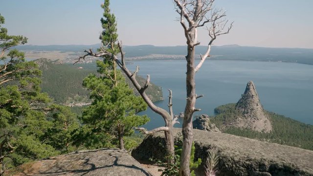 Man hiking at Lake Borovoe in Kazakhstan on cliff