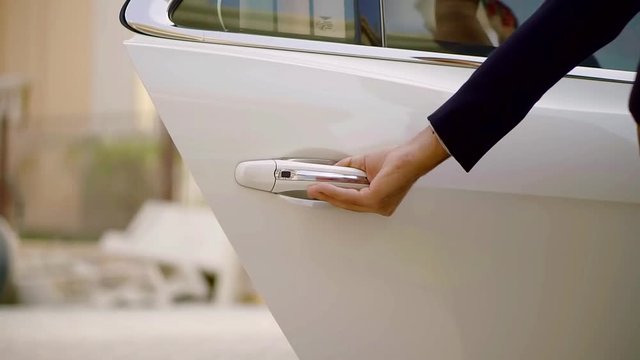 Driver opens car door for woman
