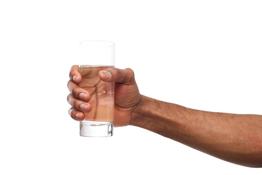 Black male hand holding glass of water isolated on white