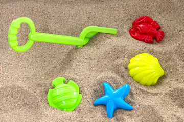 Fototapeta na wymiar Children toys on sand.
