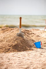 A metal spade in the sand.