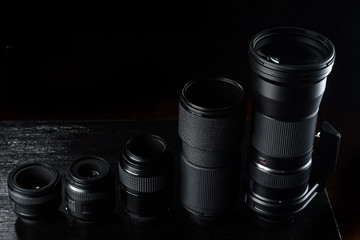 Fototapeta na wymiar different photographic lenses on a dark background