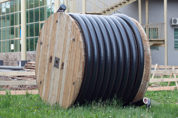 Polyethylene pipes in the coil for gas and water are liyng on the ground.