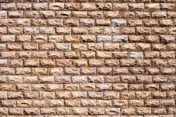 exterior finishing the walls of the house with a brown stone