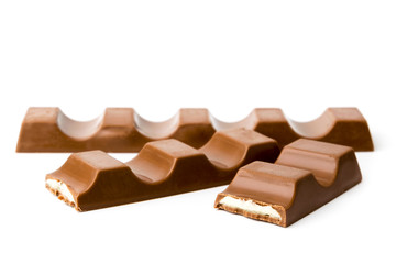 Chocolate bar and two halves on a white background.