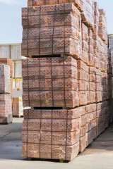 Several pallets with concrete brick stacked on top of each other in depot. new bricks on pallets
