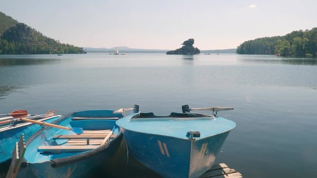 Leisure boats by lake Borovoe in Kazakhstan on summer vacation