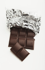Bar of dark chocolate isolated on white