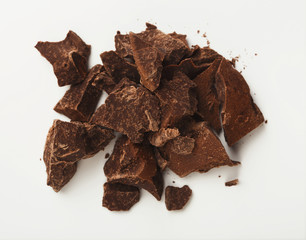Heap of chocolate pieces isolated on white