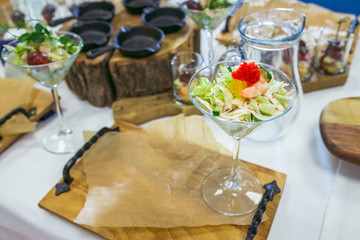 Salad with shrimp, red caviar, vegetables and greens. Seafood in restaurant. Closeup.