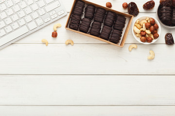 Working desktop with healthy sweets and nuts