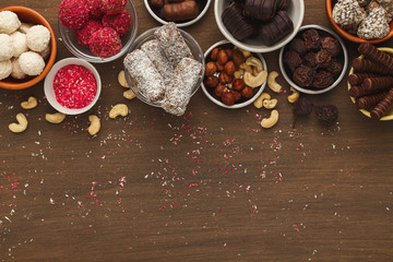 Wooden desktop with assortment of healthy sweets and nuts