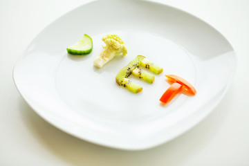 Diet. Close up of plate with vegetable diet letters