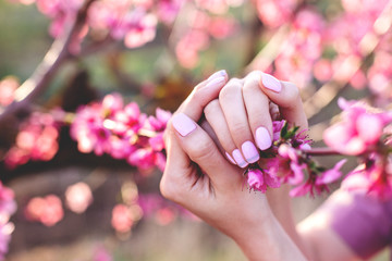Pink manicure with peach flowers.