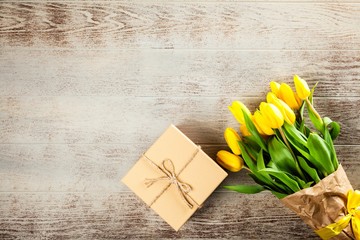 Yellow tulips on wooden background