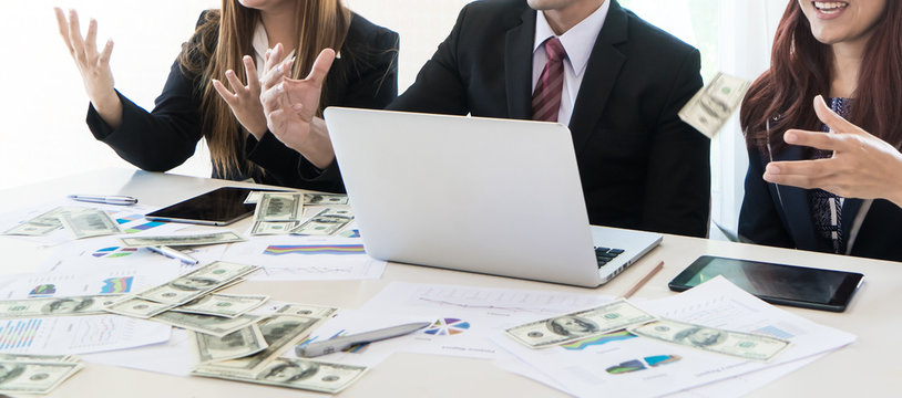Business team parter celebrating profit by throwing money