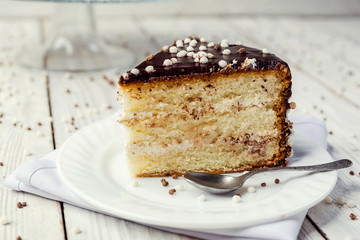 biscuit cake with caramel and chocolate on a wooden background