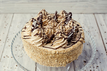 sponge cake with cream decorated by meringue and chocolate