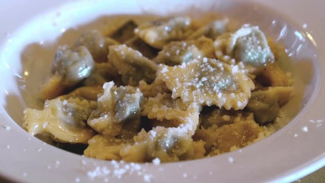 Agnolotti Anolini with parmesan traditional italian cuisine variation of ravioli pasta from Emilia Lombardy and Piedmont