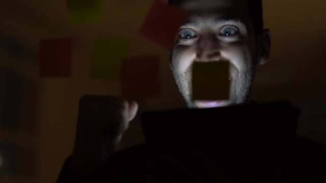 Business man celebrating on dark office