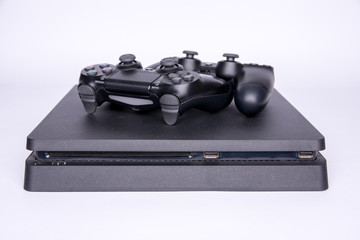 two controllers lying on the game console. White background © Adga