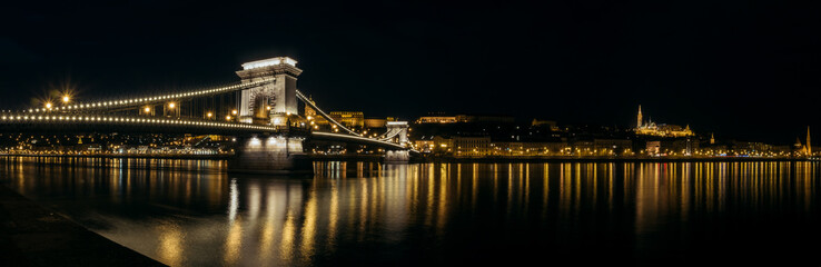 Panoramic view of Chain Bridge with the Royal Palace in the background in Budapest at night