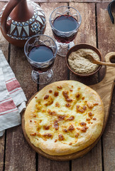 Megrelian Georgian khachapuri or cheese flatbread. Homemade baking. Top view