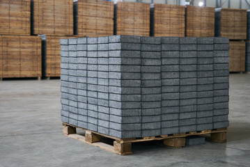 Close-up of a Concrete road curbs at the factory for the production of cement products, paving slabs. Industry manufacturing concept