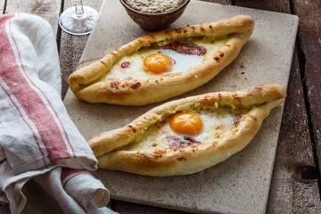 Two ajarian khachapuri, georgian bread with cheese and yolk