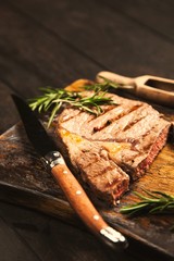 Grilled steak on wooden cutting board